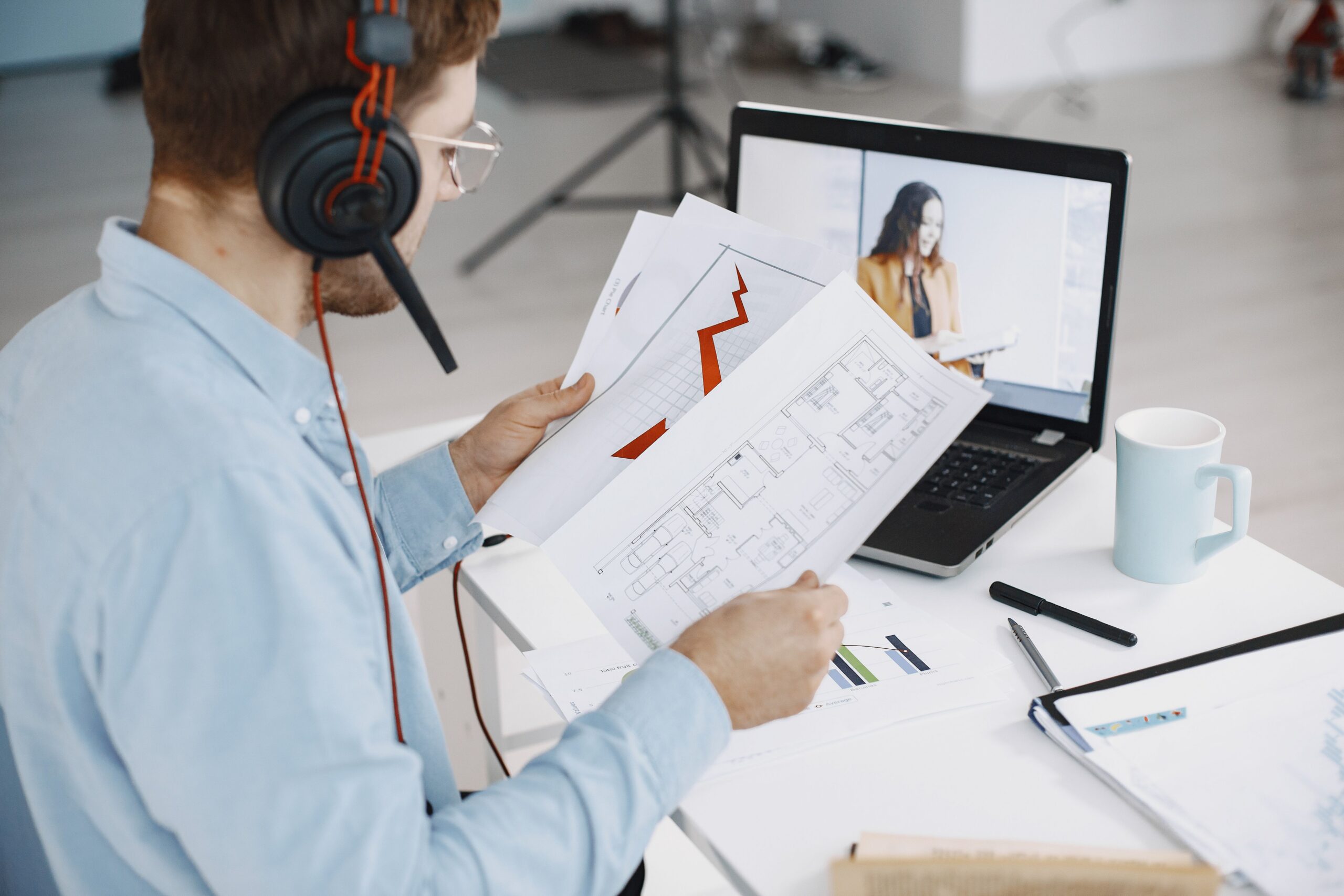 real estate team leader reviewing open files with a virtual assistant on a video call